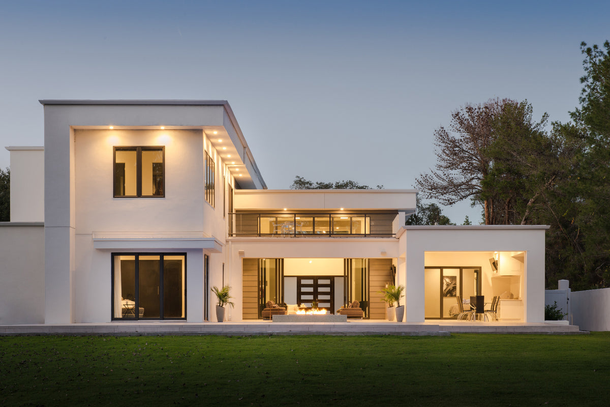 Modern house exterior with illuminated windows at dusk