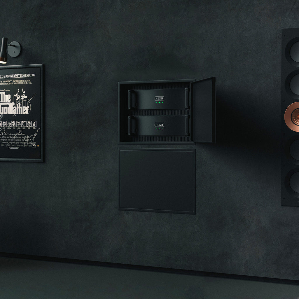 Dark wall with a framed poster of 'The Godfather' and built-in rack of Hegel C5 Series amplifiers.