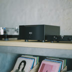 Black Hegel H30A Amplifier on a shelf with records below