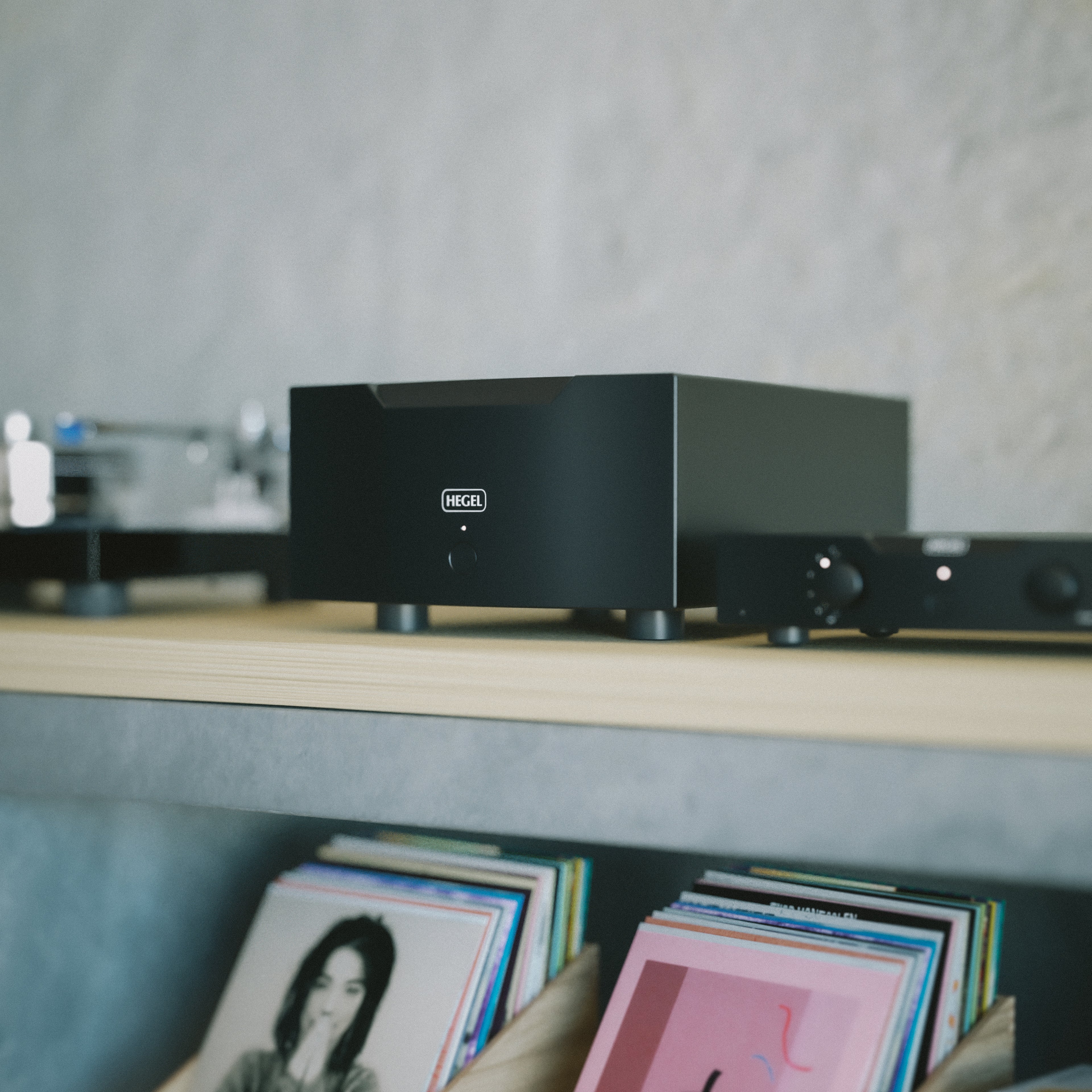 Black Hegel H30A Amplifier on a shelf with records below
