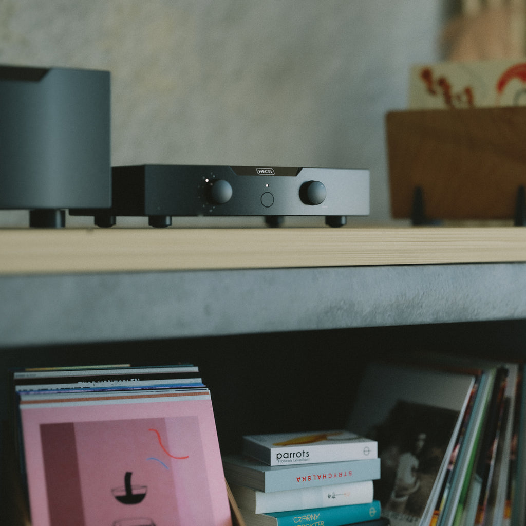 Black Hegel P30 Preamplifier on a shelf with books and records below