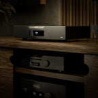 Hegel D50 DAC on a wooden shelf with a dark background